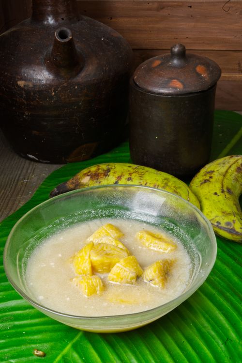 Free A traditional Indonesian dessert kolak with bananas, served in a glass bowl on a banana leaf in Surabaya. Stock Photo