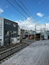 Bustling Kyoto Street with Train Passing by Station