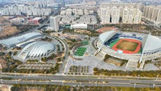 Aerial View of Modern Stadium Complex and Surrounding Cityscape
