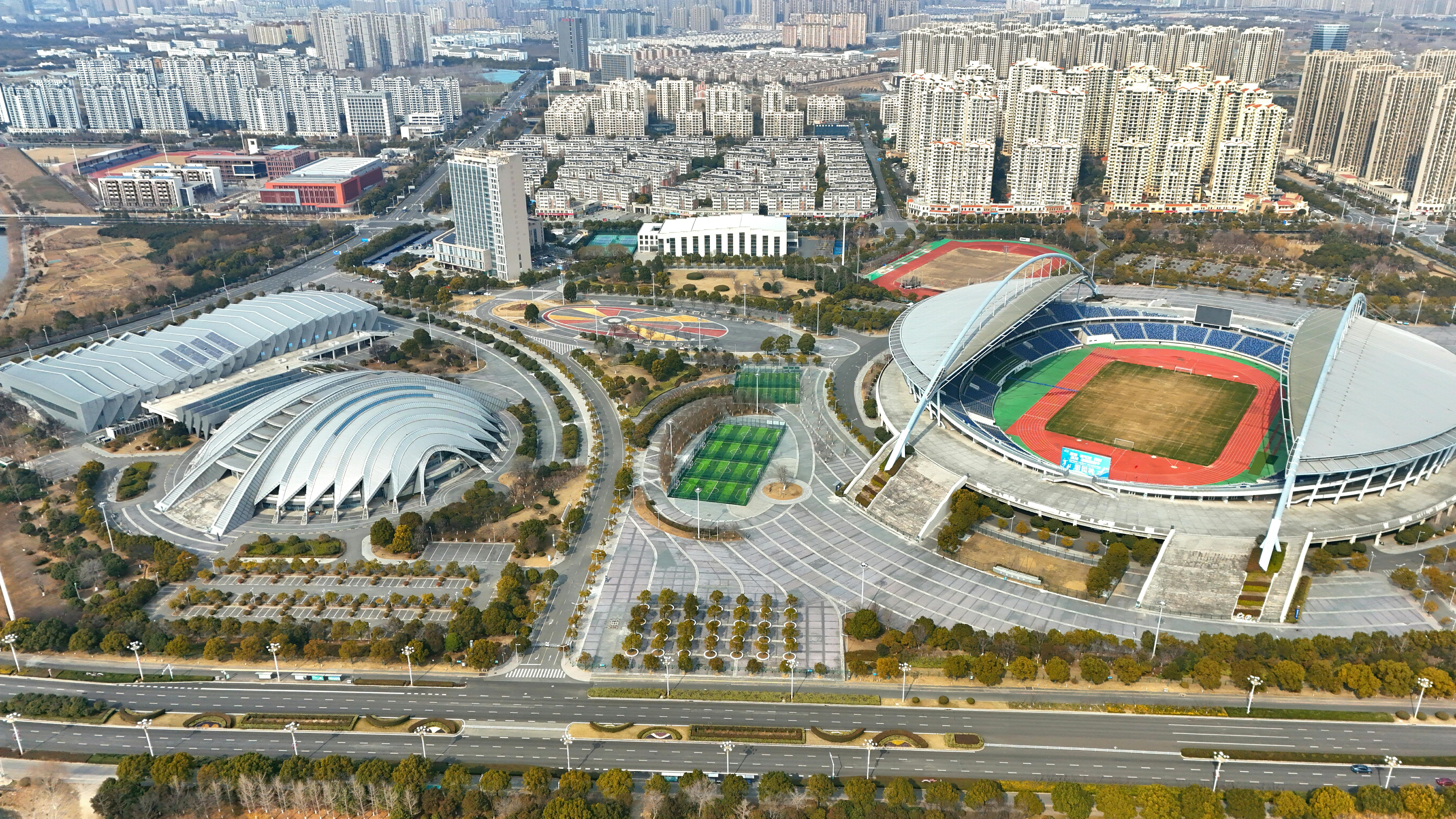 Aerial View of Modern Stadium Complex and Surrounding Cityscape