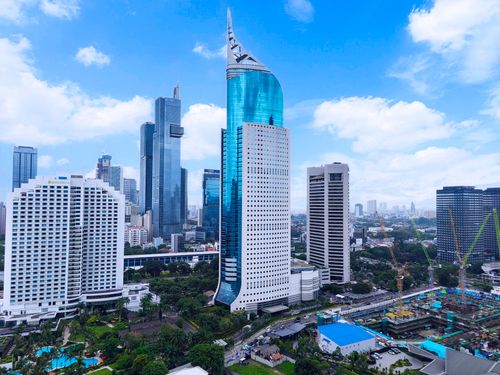 Free Aerial view of Jakarta featuring the iconic Wisma 46 and nearby skyscrapers. Stock Photo