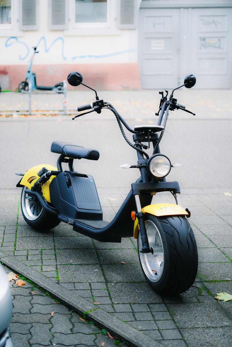Yellow electric scooter parked outdoors - Switching to Electric Scooter Commuting