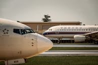 Commercial airplanes on airport runway at sunset