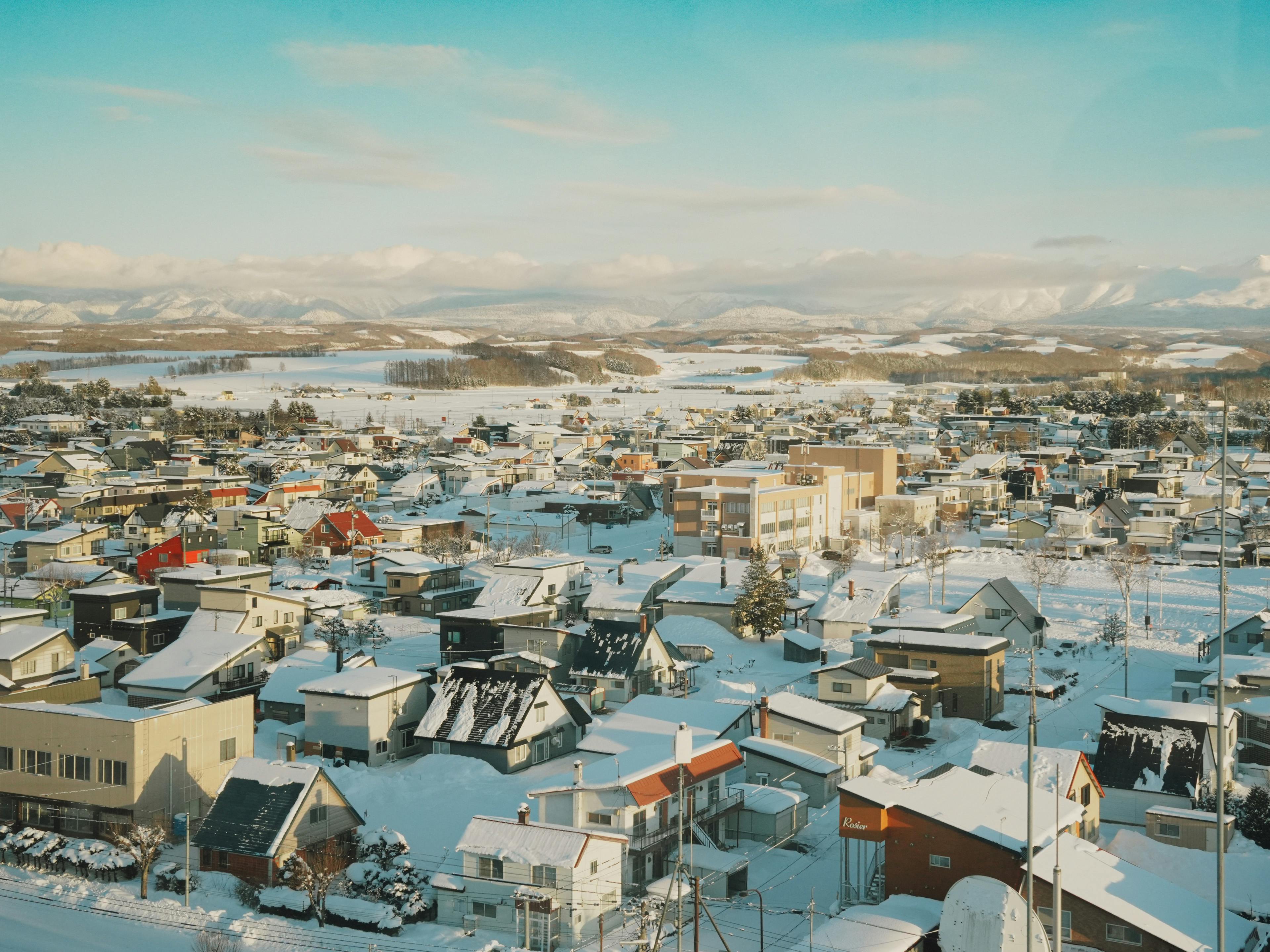 Scenic aerial view of a snow-covered town in Hokkaido, Japan during winter.