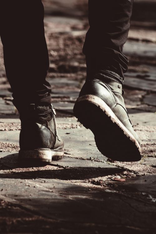 Stylish Boots on Cobblestone Street · Free Stock Photo