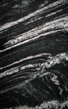 Close-up view of black and gray sedimentary rock texture with natural patterns and layers.