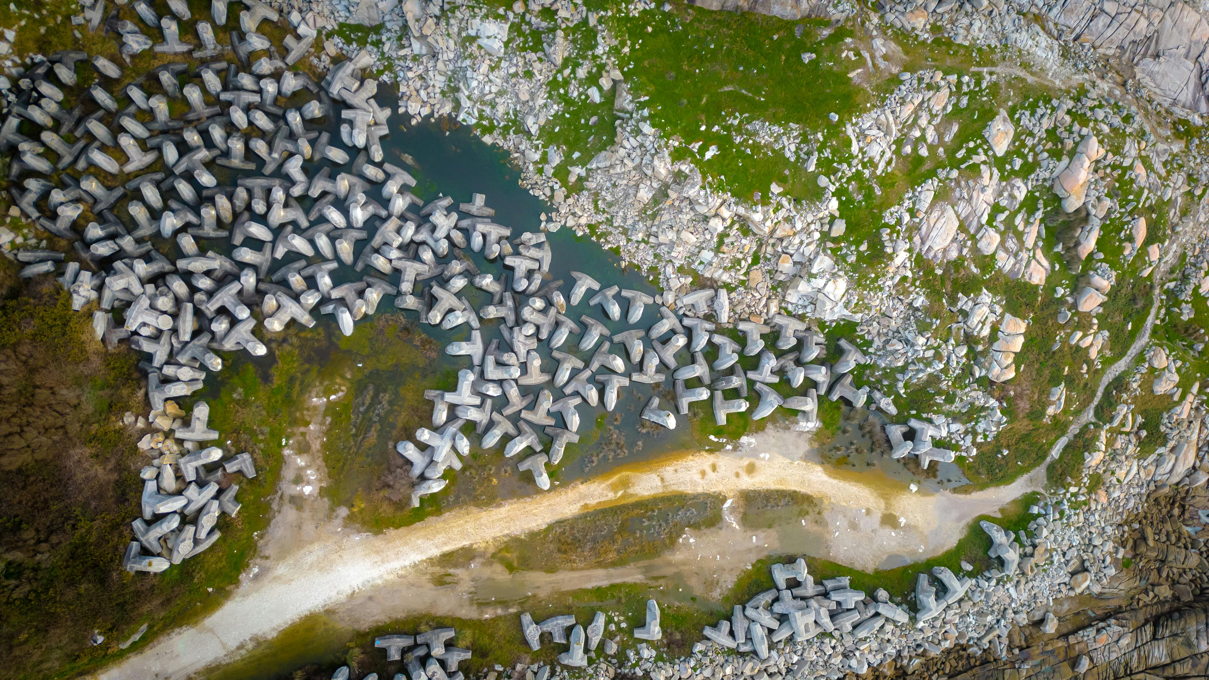 Aerial photograph of concrete dolosse along the Lugo coastline, Spain, showcasing coastal erosion prevention structures.