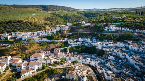 Free Stunning aerial view of Setenil de las Bodegas, featuring whitewashed houses nestled in the Andalusian hills. Stock Photo