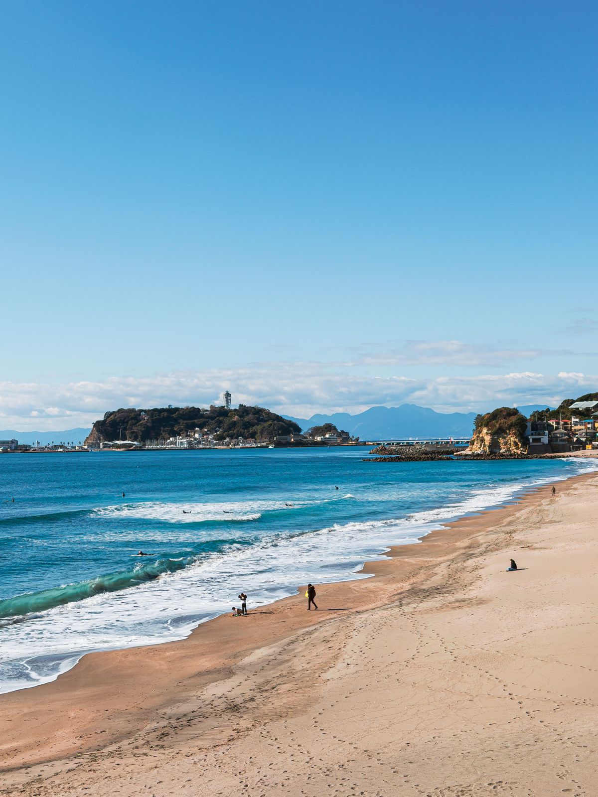 Scenic beach view of Enoshima island with the Pacific Ocean in foreground