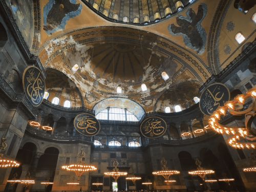 Free Stunning interior view of Hagia Sophia's dome with intricate designs and lighting. Stock Photo