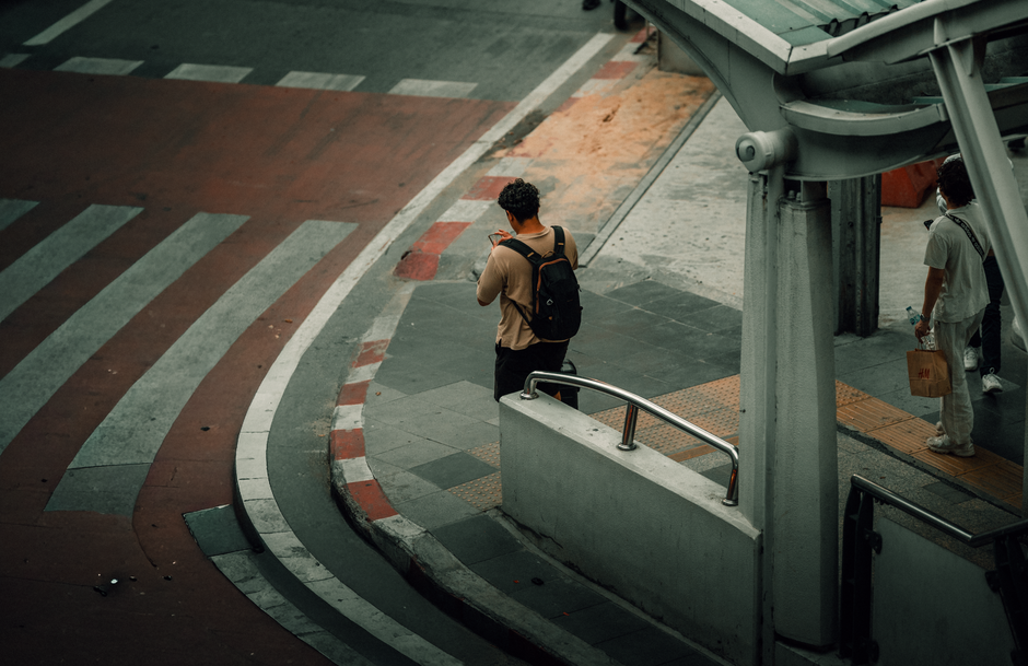 bystanders on sidewalk recording phones
