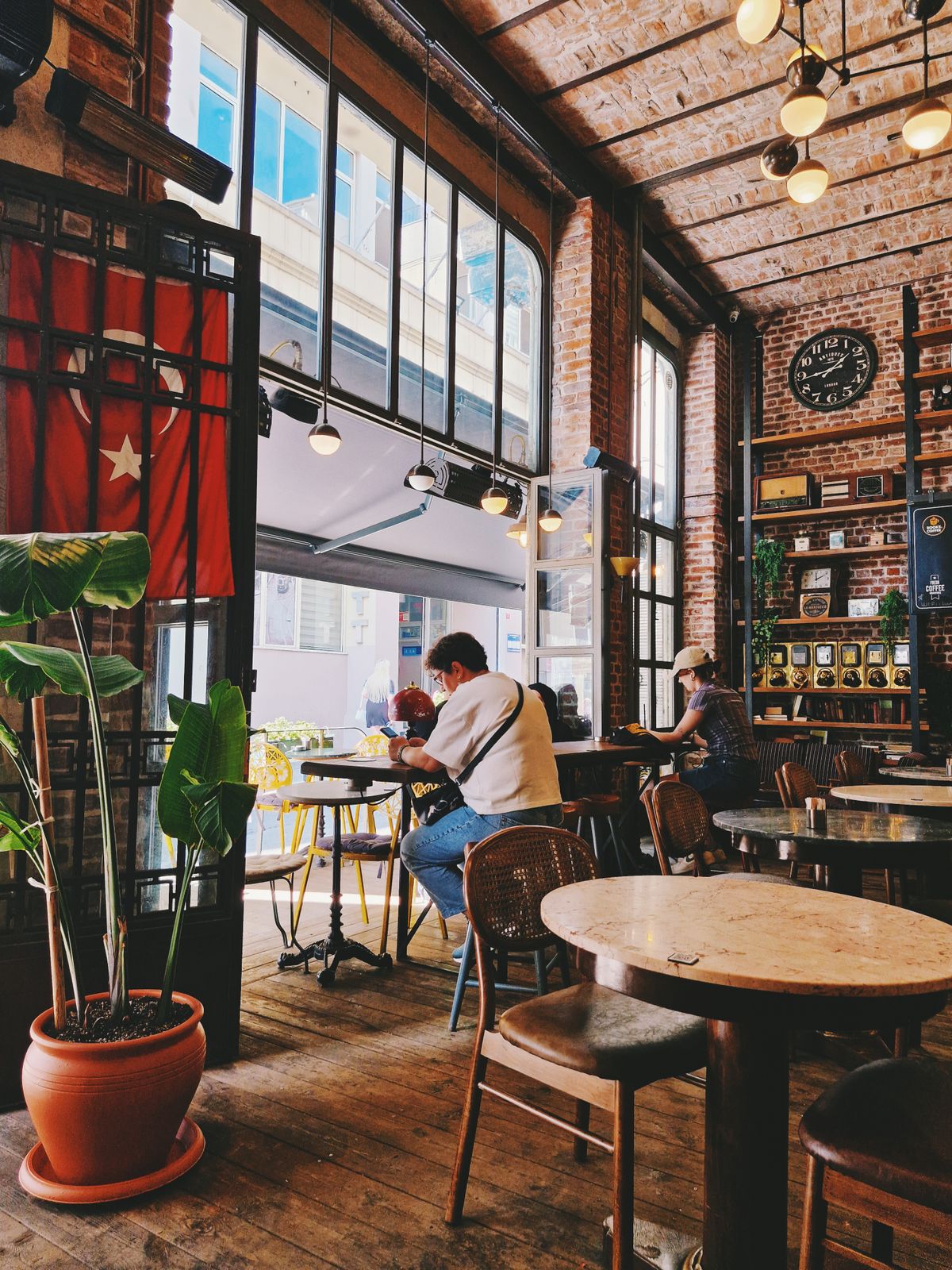 The interior of a small café, brick walls and warm low lighting.