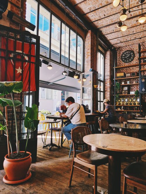 Free Charming café in İstanbul with brick walls and warm lighting, capturing a relaxed ambiance. Stock Photo
