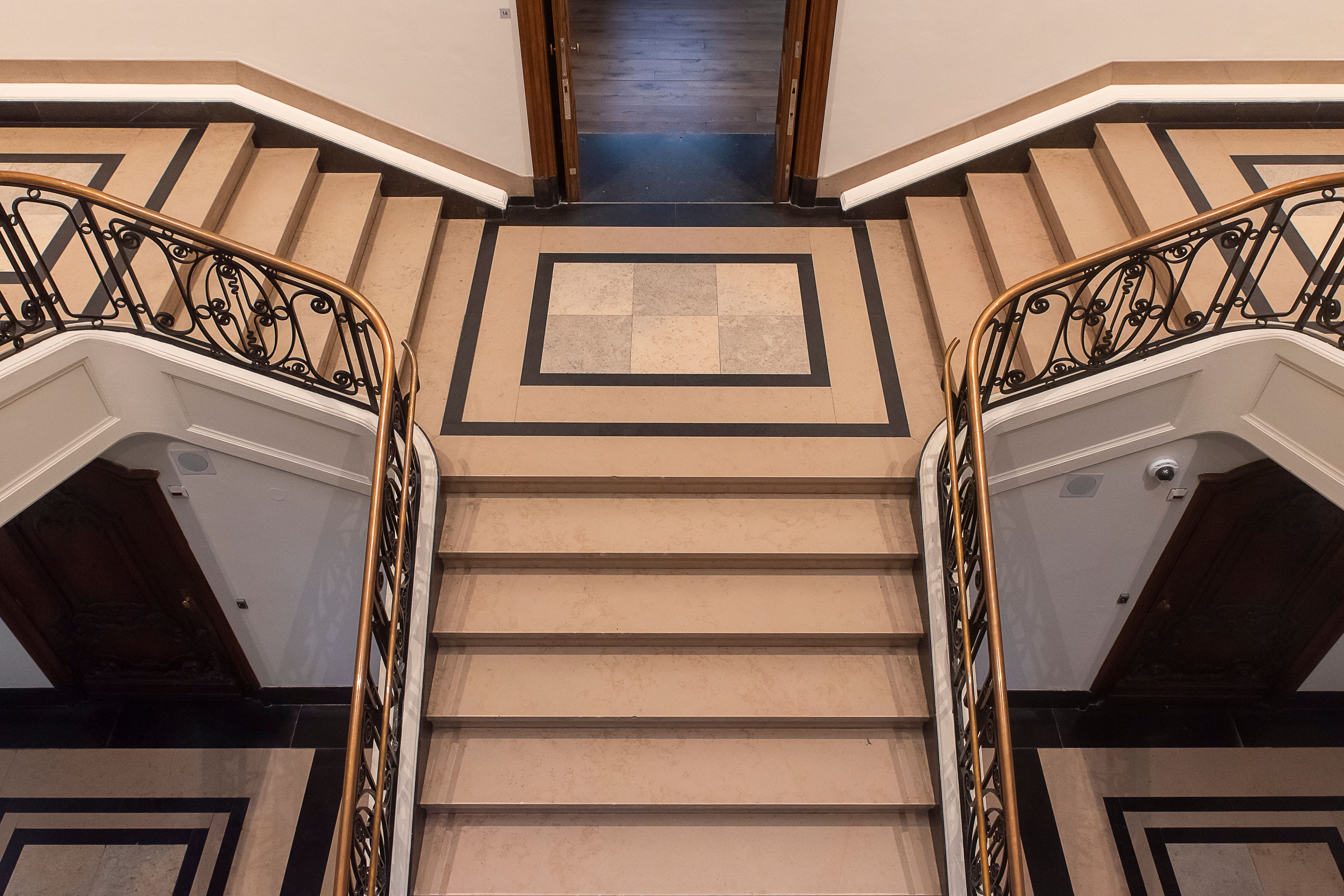 Elegant curved marble staircase in grand foyer setting