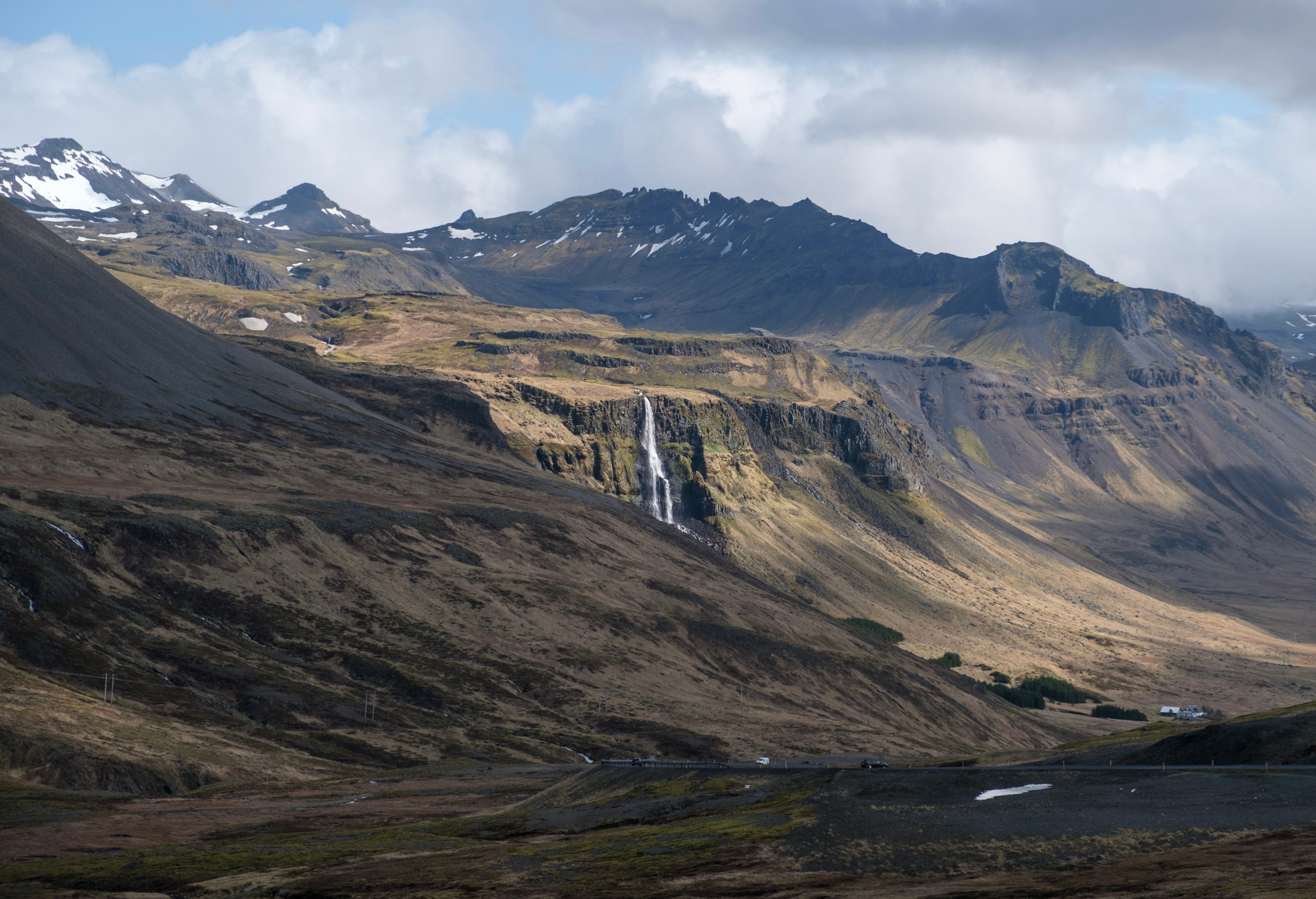 Majestic Icelandic Waterfall Amidst Rugged Mountains · Free Stock Photo