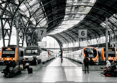 Free A bustling scene at a train station in Barcelona, capturing modern trains and iconic architecture. Stock Photo