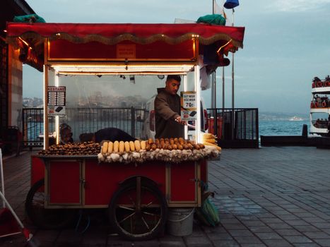 Street vendor selling roasted corn and chestnuts by the Bosphorus in Eminonu.