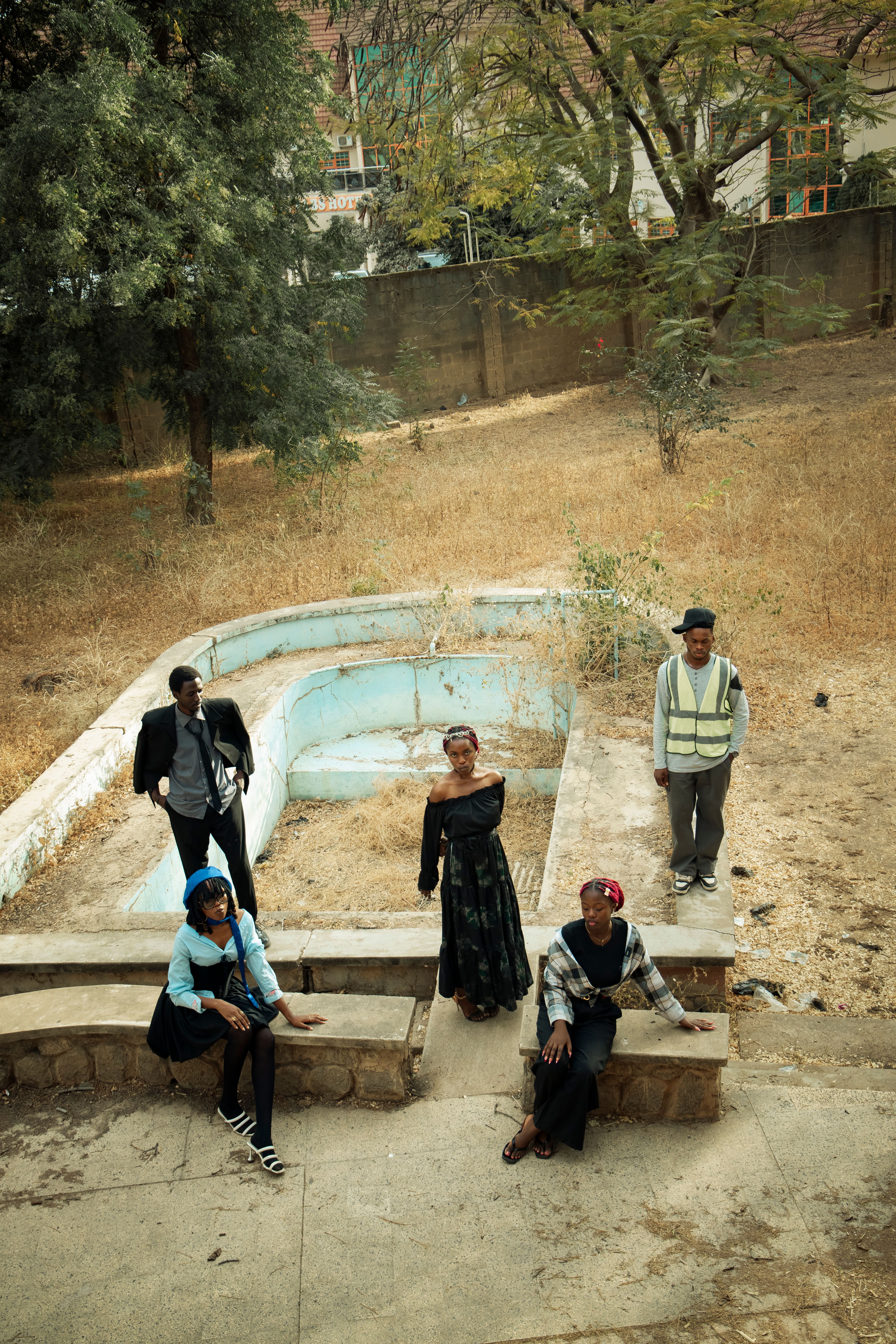 Group of People Posing in an Empty Pool Area · Free Stock Photo