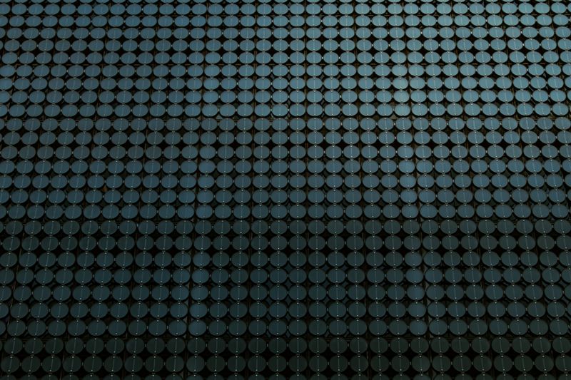 A close-up of a silicon wafer showing a uniform array of microfabricated dies