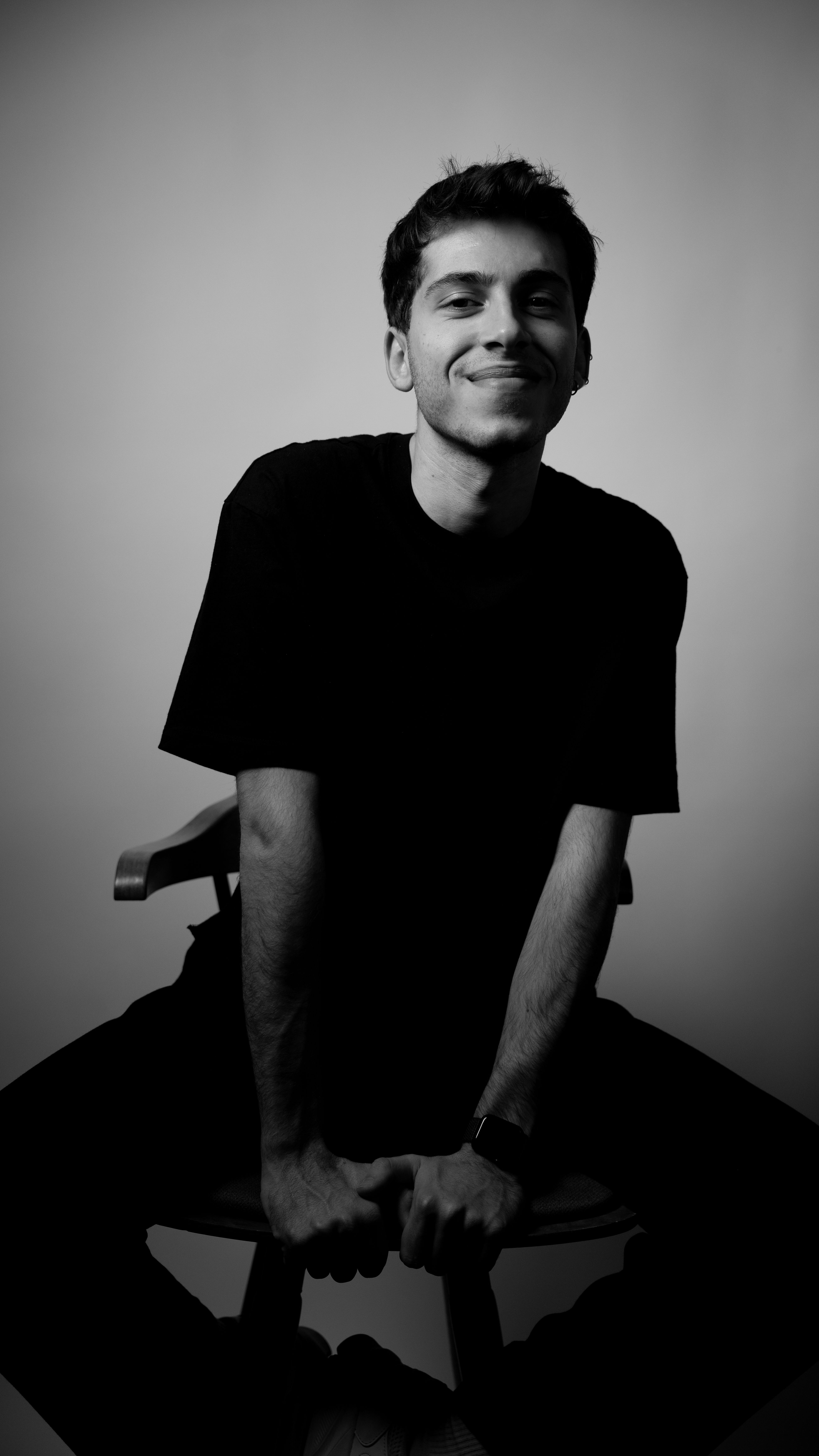 Striking black and white portrait of a smiling man, adding depth and emotion.