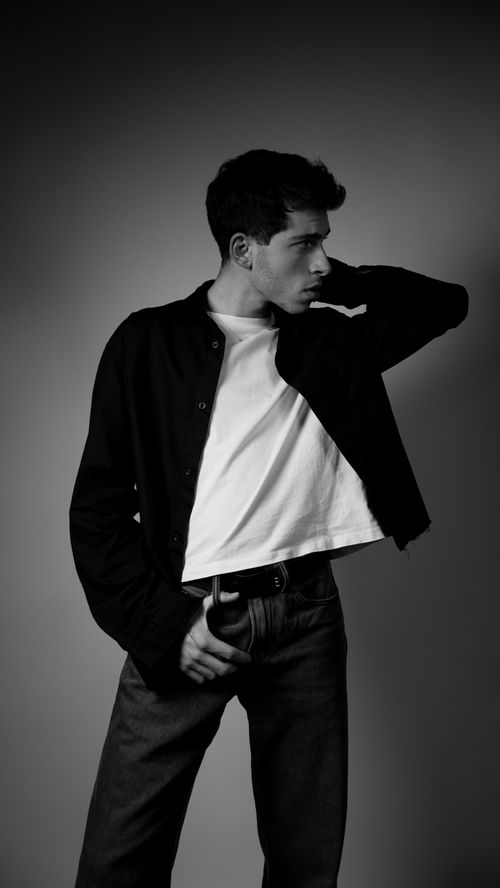 Free Striking black and white portrait of a male model posing in a studio setting. Stock Photo