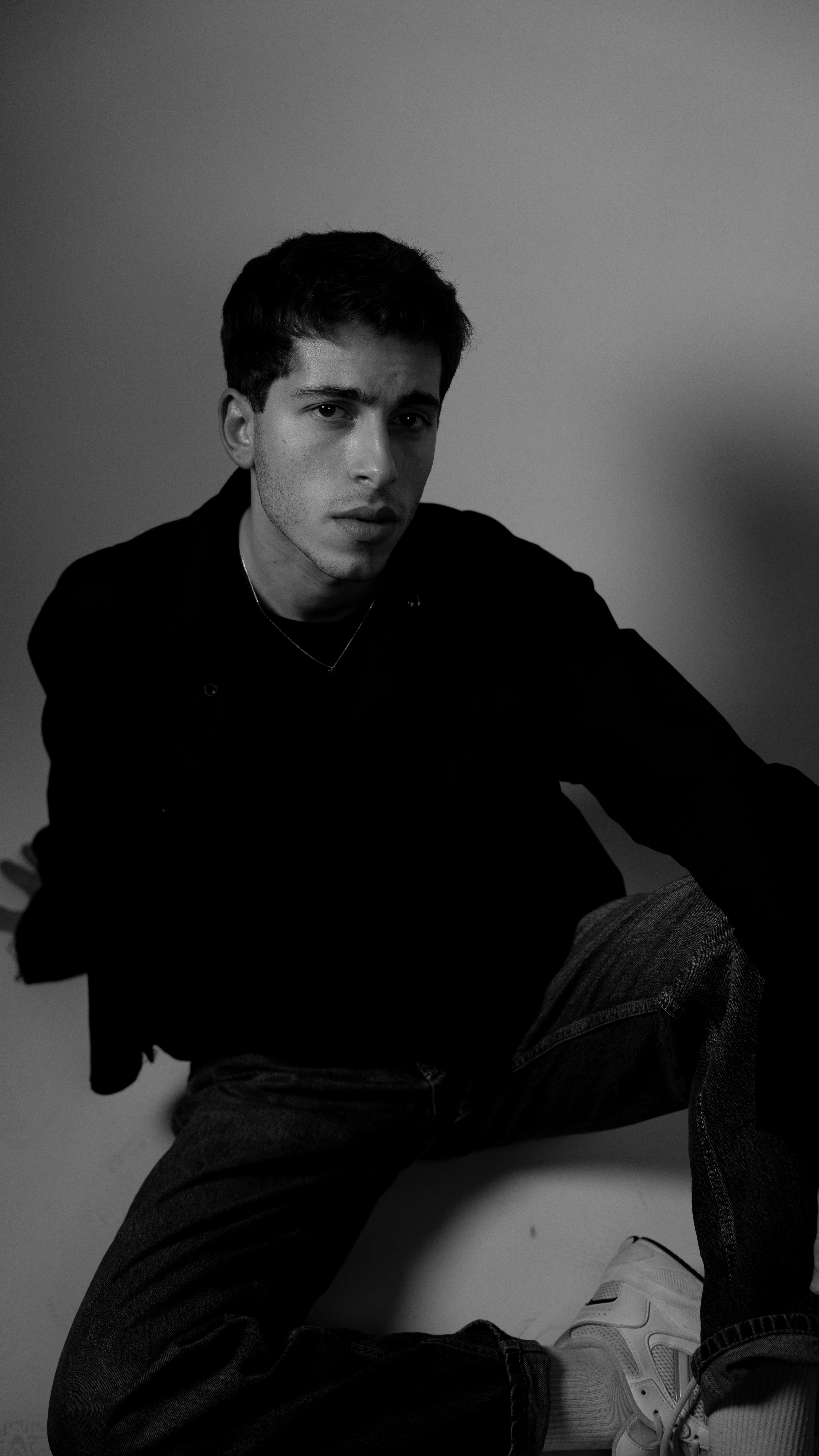 免费 一张充满情绪的黑白肖像照，拍摄对象是一位在摄影棚内的年轻男子。 素材图片