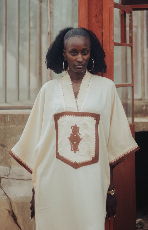 Free Portrait of a stylish woman in traditional attire with an urban backdrop, highlighting cultural elegance. Stock Photo