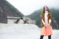 Fashionable Woman in Misty Mountainous Landscape