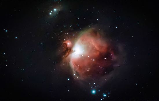 A breathtaking image of the Orion Nebula (M42) captured in deep space, showcasing vibrant cosmic colors.