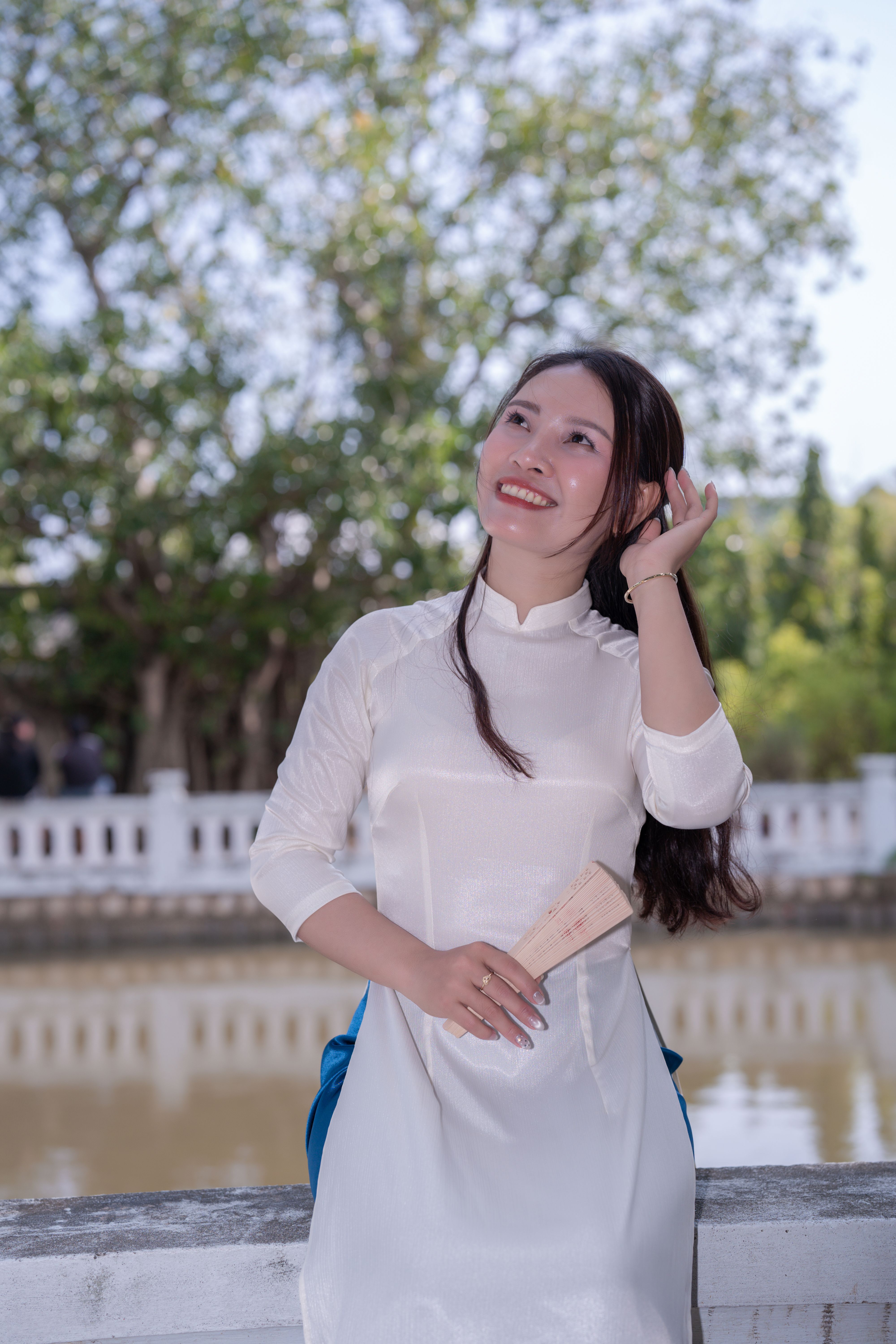 Smiling Woman in Traditional White Dress Outdoors · Free Stock Photo