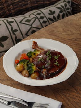 A savory plate of roast duck with vegetables, perfect for a gourmet meal setting.