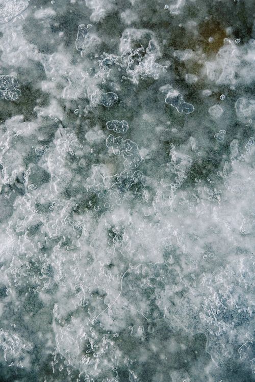 Free Close-up of ice and snow patterns forming a textured abstract art on a frozen surface in winter. Stock Photo