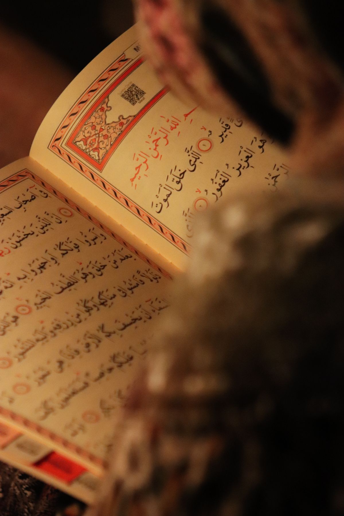 Holy Quran being studied in warm light