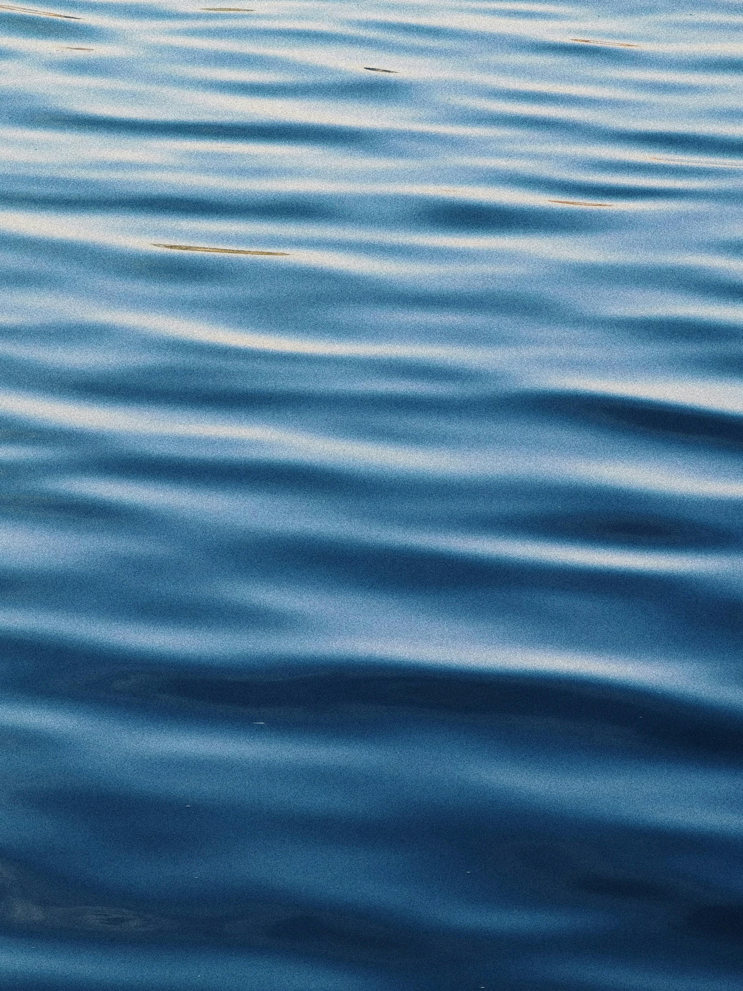 бесплатная Спокойная голубая океанская вода с легкой рябью создает умиротворяющую текстуру и безмятежную атмосферу. Стоковое фото