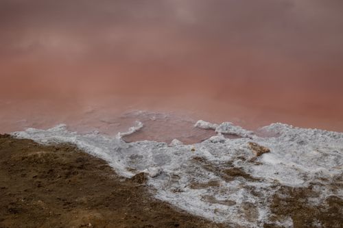 Free Stunning view of a salt-encrusted shoreline meeting a pink-hued lake in Namibia. Stock Photo