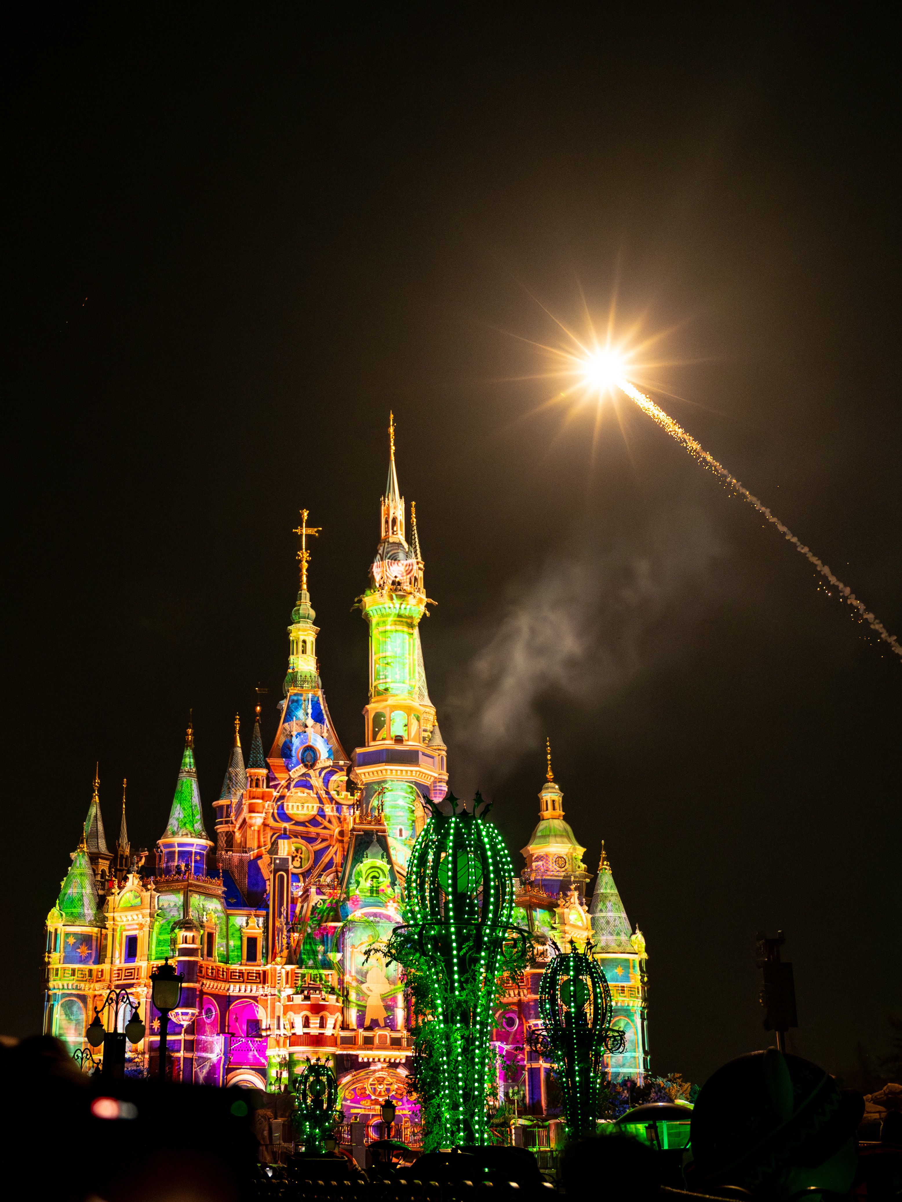 Stunning fireworks illuminate the Shanghai Disneyland castle at night with vibrant colors.