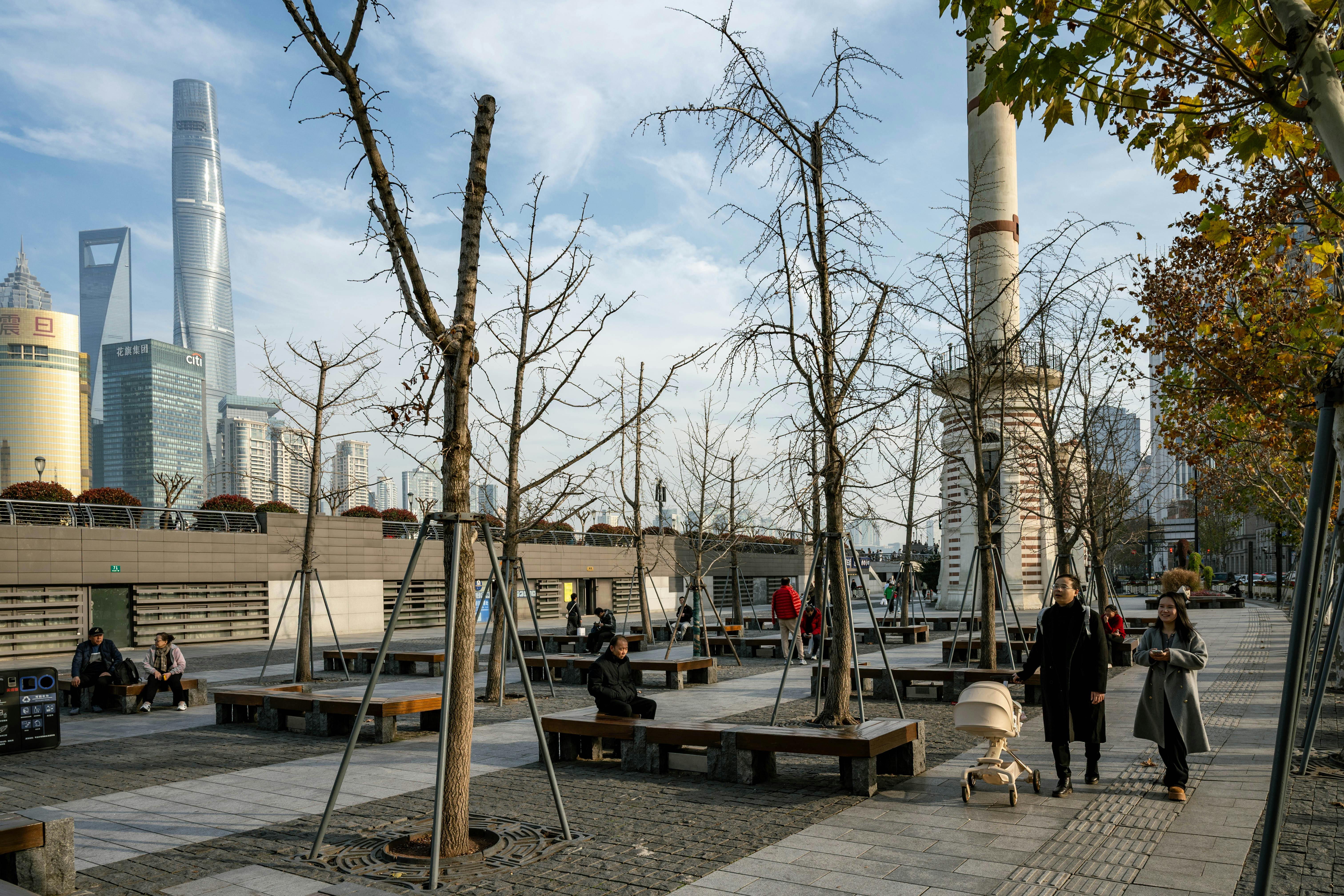Modern urban park in Shanghai with view of iconic skyline and people enjoying the day.