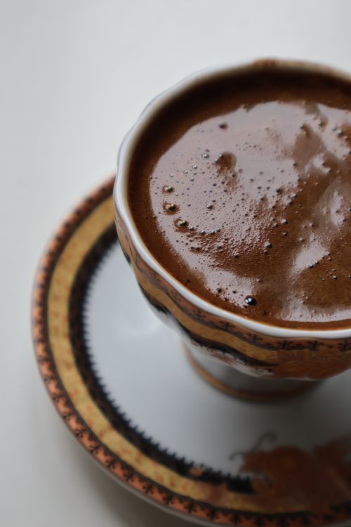 Free Elegant close-up of frothy Turkish coffee in ornate cup and saucer. Stock Photo