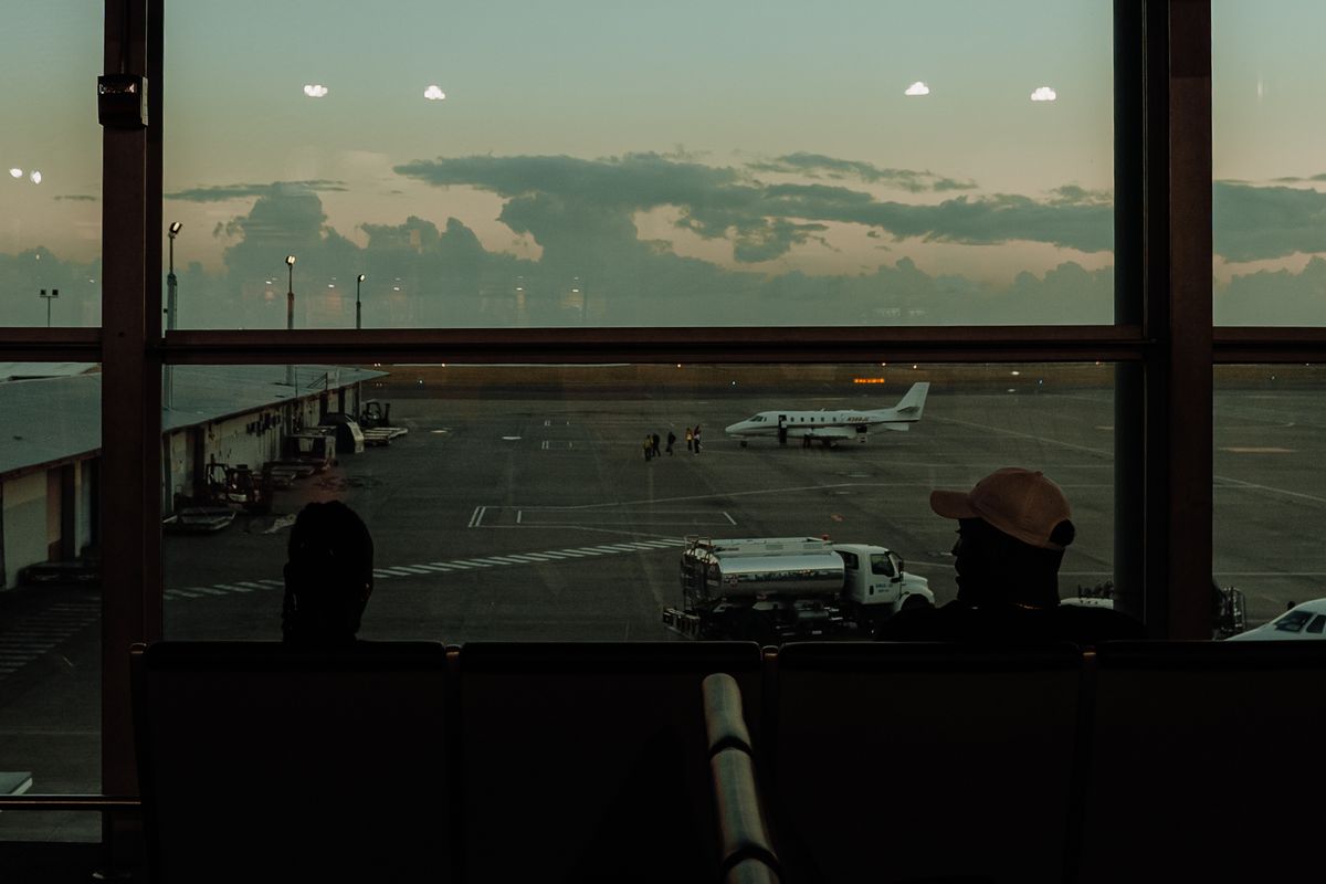 Dark airport gate area with a view of the apron