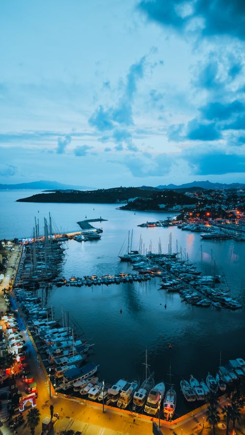 Free Stunning aerial view of Bodrum Marina in Türkiye during twilight, showcasing boats and sparkling city lights. Stock Photo