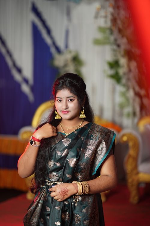 Free Woman wearing traditional attire attending a festive indoor celebration with vibrant colors. Stock Photo
