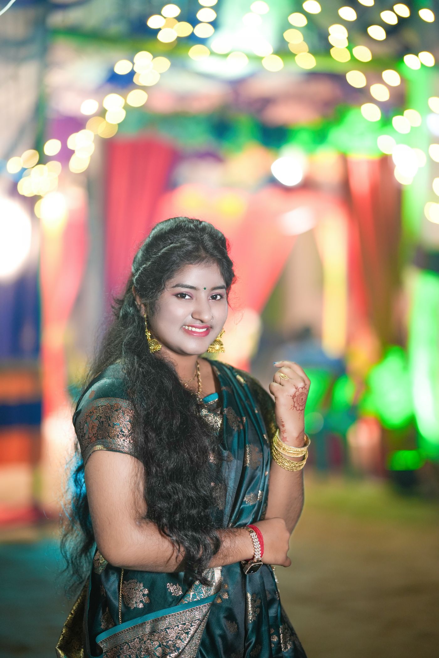 Elegant Indian woman in festive party styling with visible jewellery and evening lights