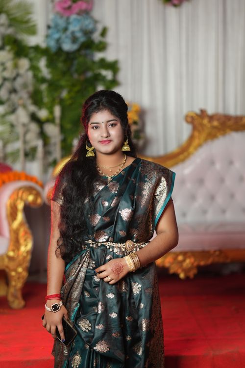 Free Beautiful woman in traditional Indian saree posing gracefully indoors with elaborate decor. Stock Photo