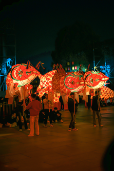 Colorful dragon lanterns illuminated at night during a traditional festival.