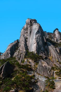 Breathtaking view of the iconic Huangshan mountain peaks under a clear blue sky.
