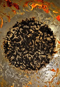 Close-up of burnt food leftovers in a large cooking pan, offering a textured view.