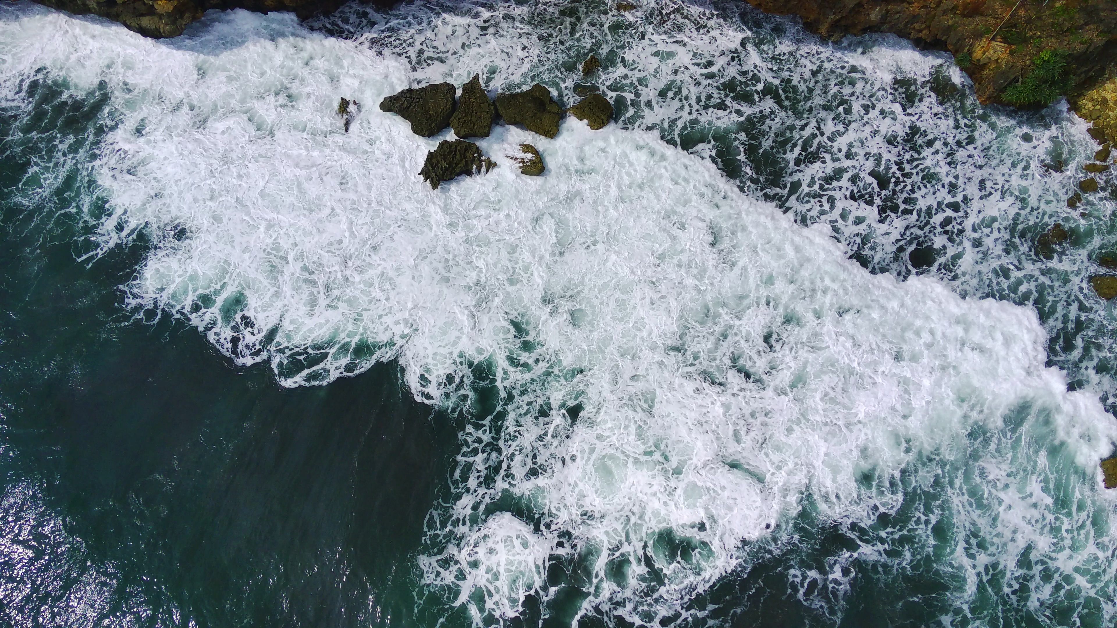 Aerial View of Ocean Waves Crashing on Rocks · Free Stock Photo
