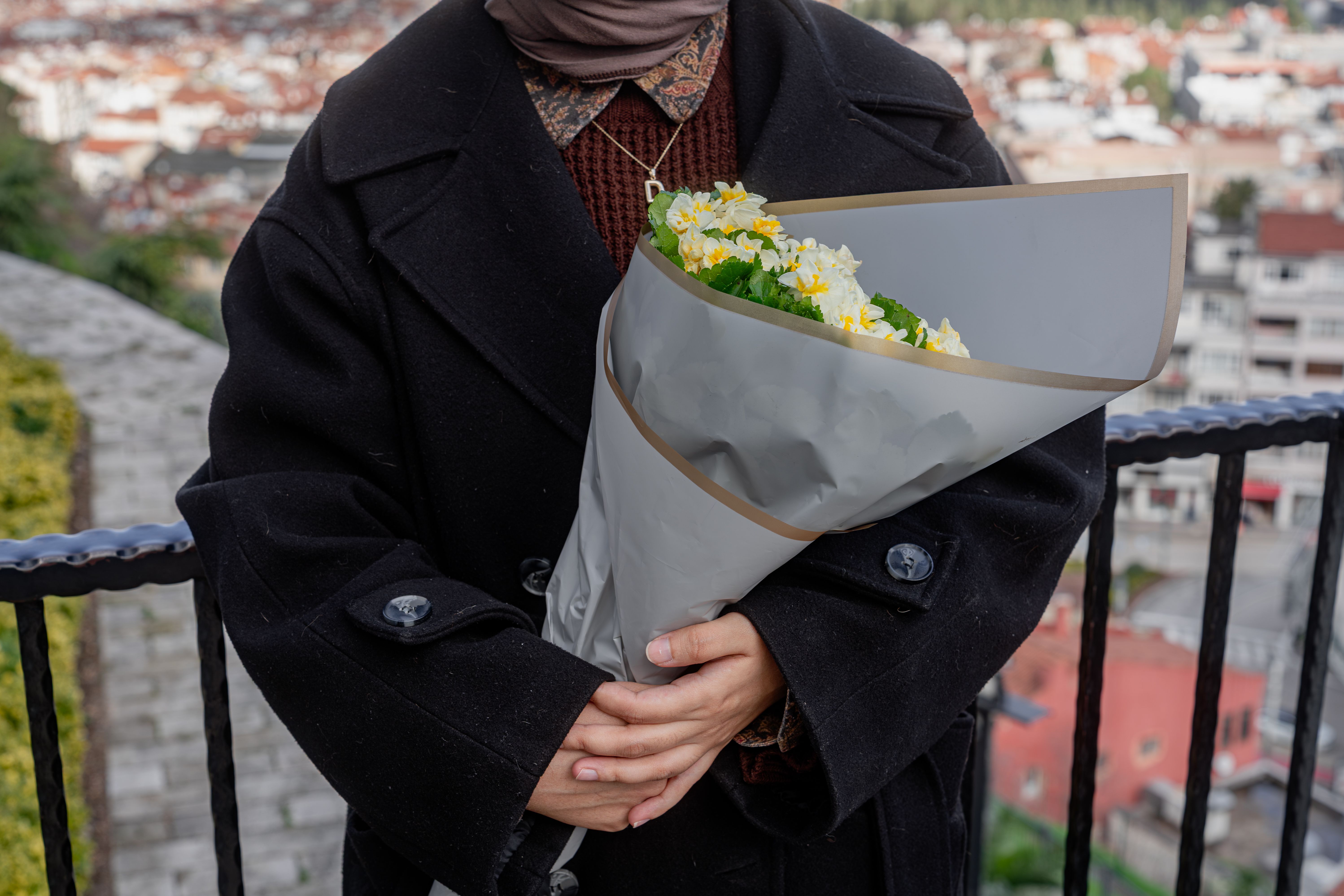 A florist wrapping a bouquet in tissue paper ready for delivery