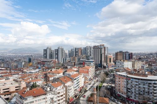 Free Dynamic city landscape showcasing urban growth with skyscrapers and historic buildings under a vibrant sky. Stock Photo