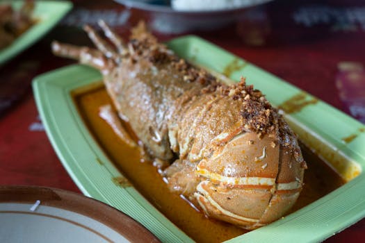 Tantalizing lobster plated with curry spices in a vibrant dining setting.